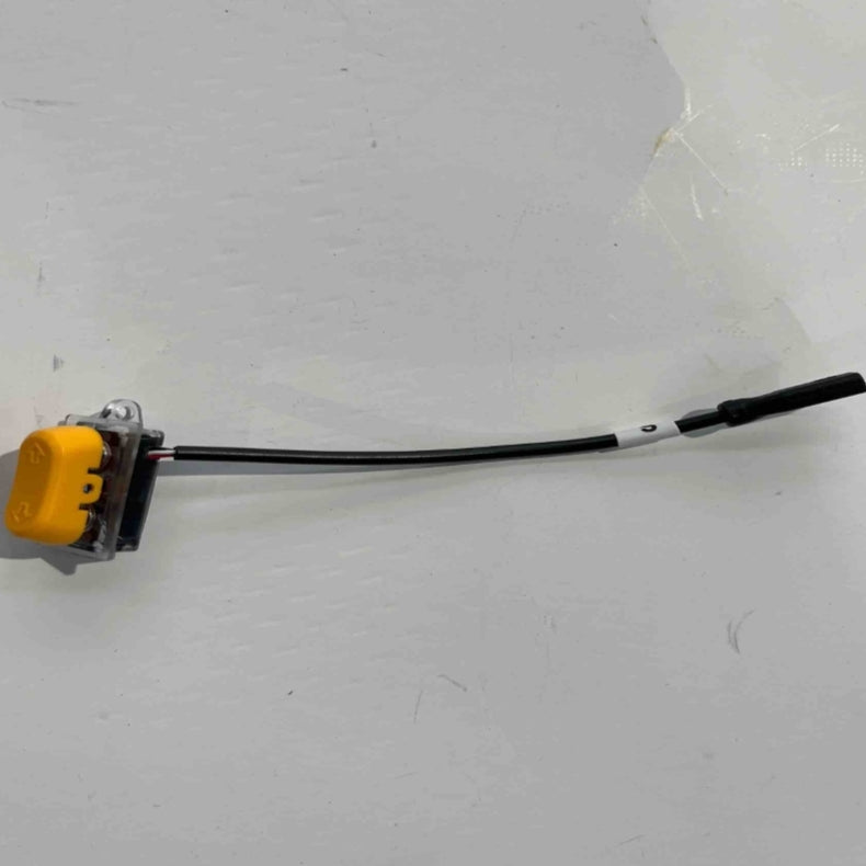 The ES600P steering switch by Go2place-okai-parts, part number 2011400065, has a yellow casing and is connected to a black wire with a black cylindrical connector at the other end, positioned on a white surface.