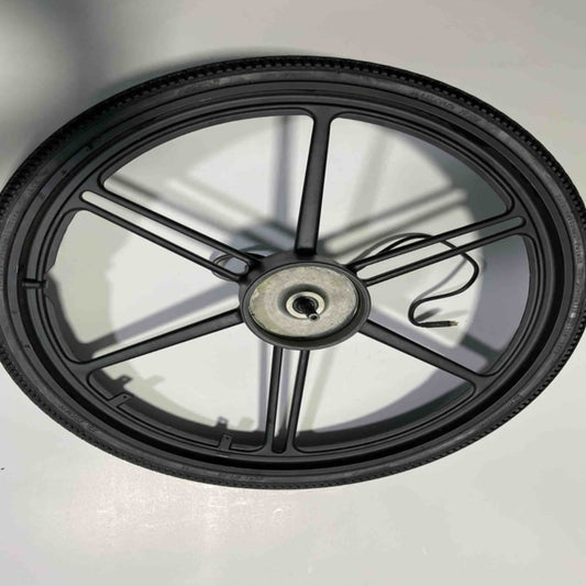 A Go2place-okai-parts EB100B rear wheel set with five black spokes lies flat on a white surface. A cable is coiled around the axle, casting shadows from the spokes that create a star-like pattern.